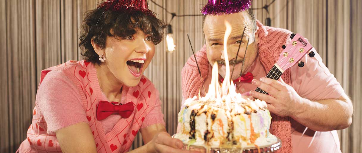 Deux personnes devant un gâteau de fête