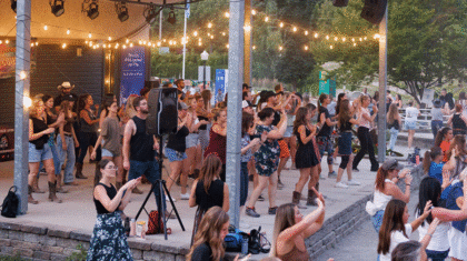 Des gens qui dansent le country sur la scène du Village des arts au Centre de la Nature